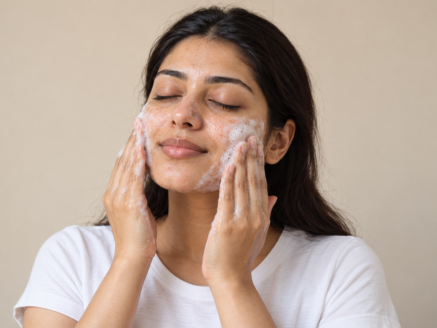 Woman gently cleansing her face